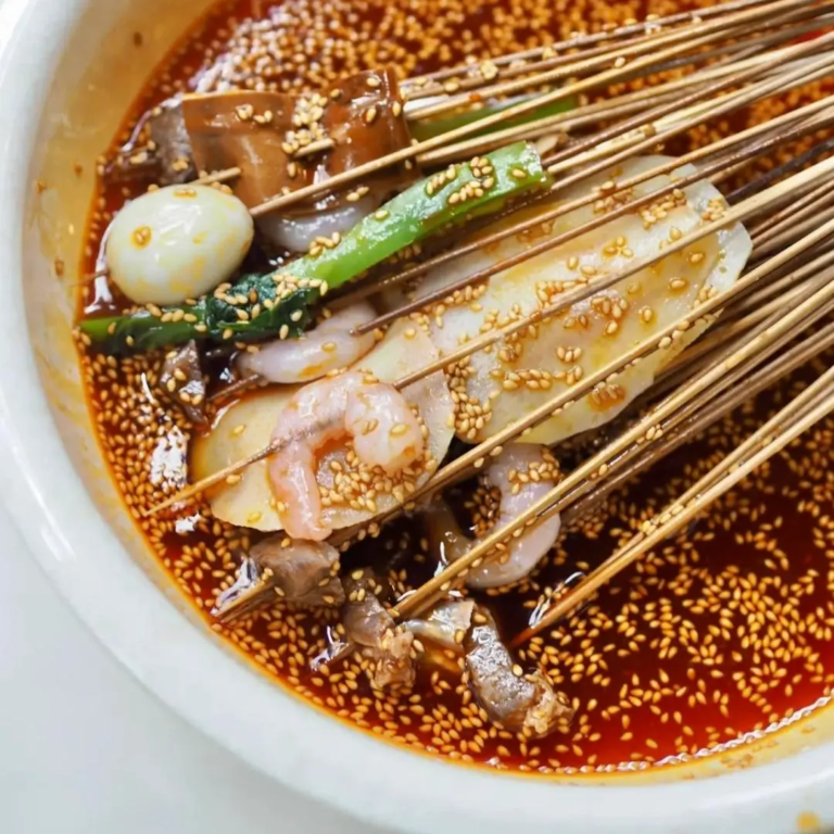 Traditional bo bo ji skewers served in Sichuan with chili seasoning