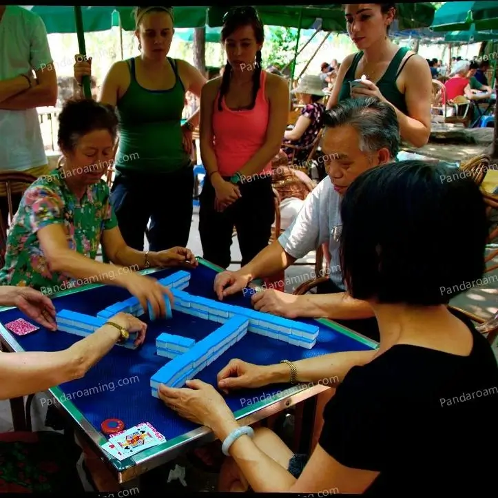 Young travelers watching locals play mahjong in Sichuan during their trip