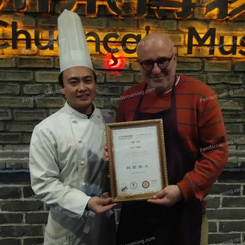 A traveler holding a Sichuan Cuisine Master sign during a cooking experience in Chengdu