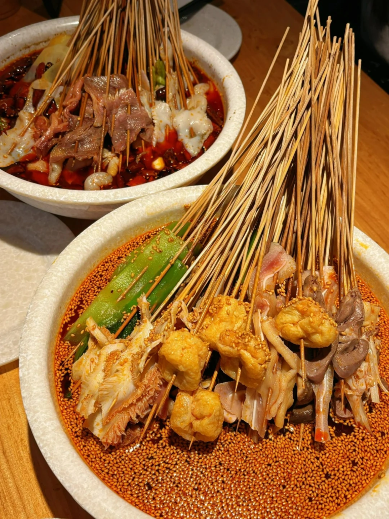 Traditional Sichuan bobo chicken served with spicy skewers