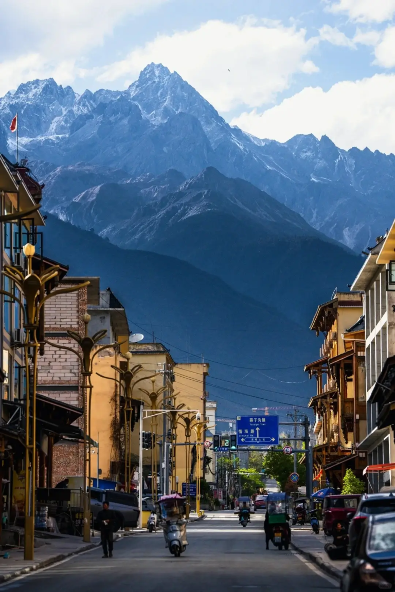 Street view of Moxi ancient town with snow mountains in the background