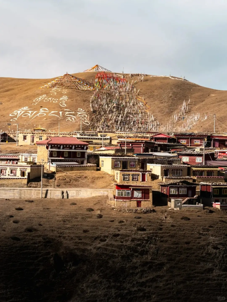 Muya Temple on a mountain with prayer flags and Tibetan scriptures