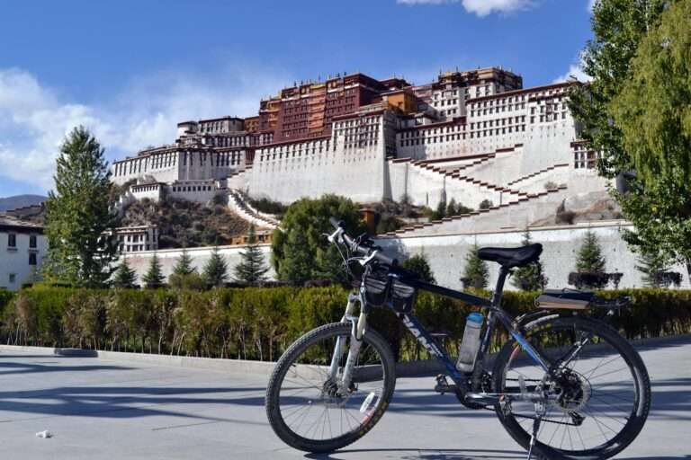 Bicycle parked before the majestic Potala Palace, a UNESCO World Heritage site in Lhasa, Tibet.
