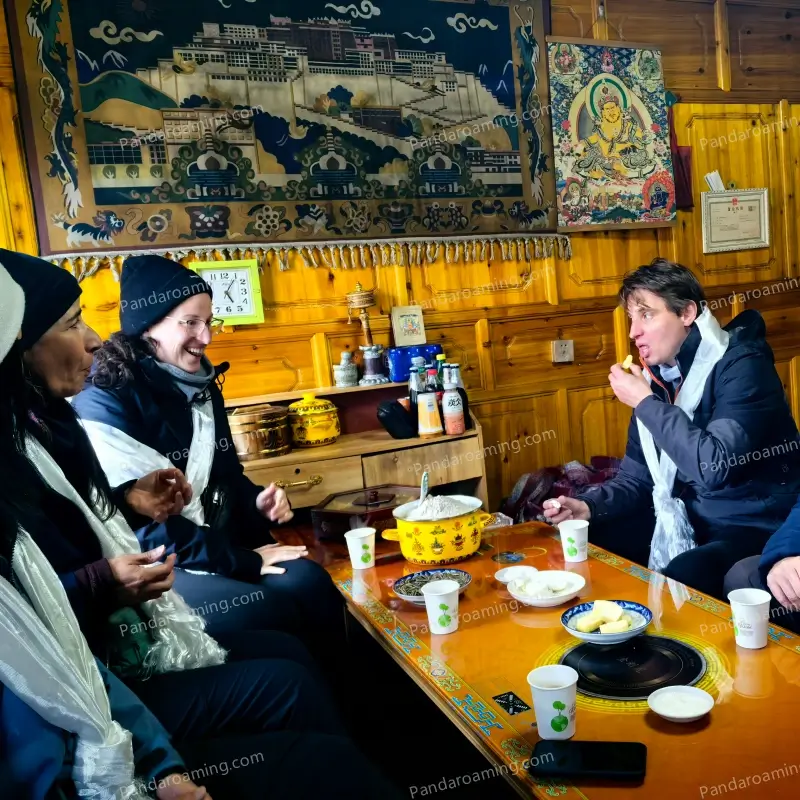 A traveler learning to make tsampa inside a Tibetan home during a cultural experience