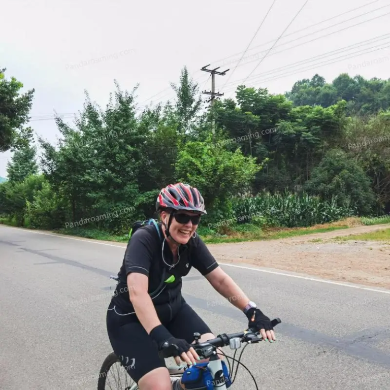 A traveler enjoying a cycling experience on an open road in Western Sichuan