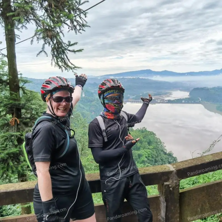 A female traveler with a guide on a bridge with a river view during a cycling tour in Western Sichuan
