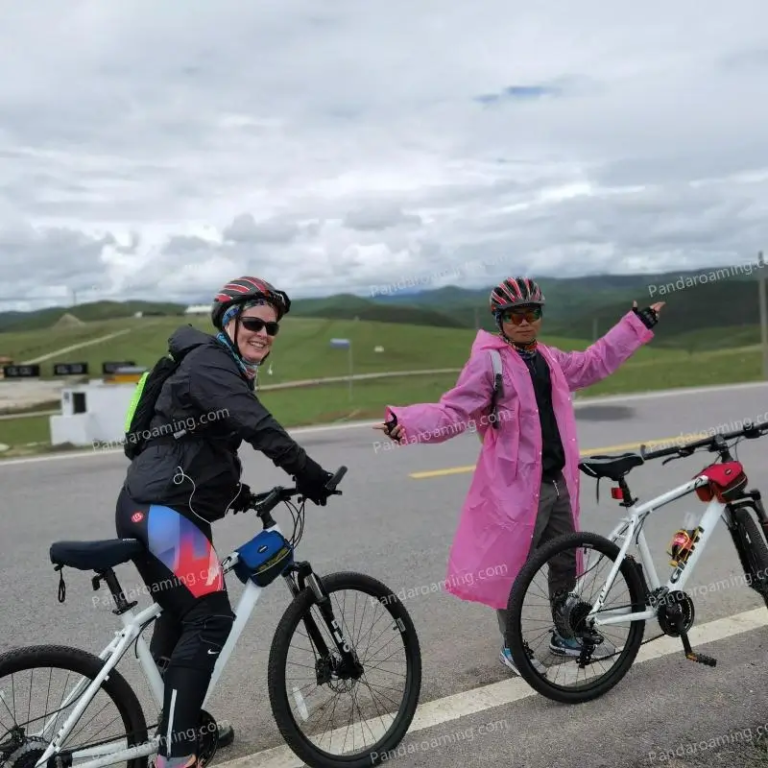 A traveler and guide standing with bicycles on an open road in Western Sichuan