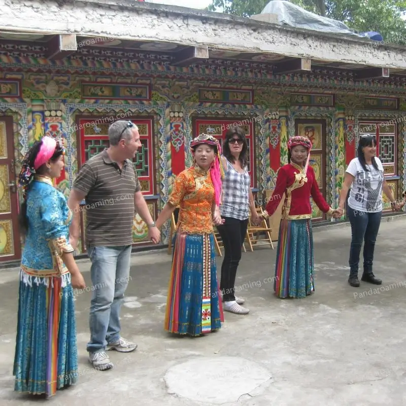 Travelers holding hands with Yi ethnic locals during a traditional dance experience in earlier years