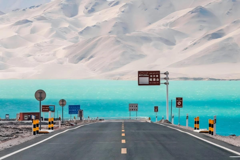 Scenic road along Baisha Lake in Xinjiang with mountain views