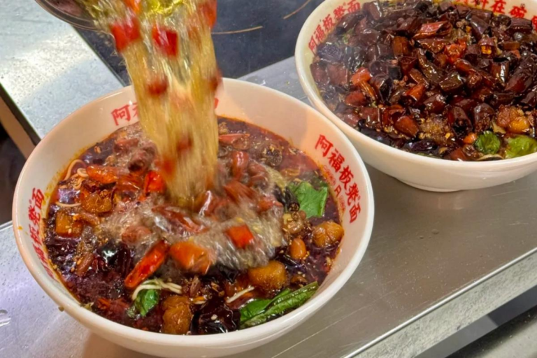 Chongqing noodles topped with spicy chicken and Sichuan-style seasoning