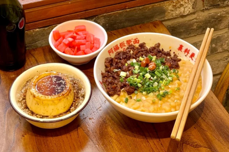 Chongqing wanza noodles with tender peas, minced pork topping, and Sichuan seasoning