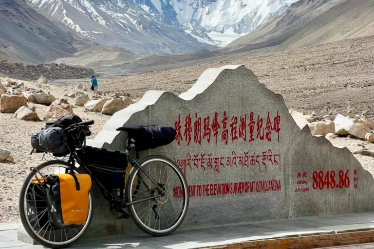 Everest Base Camp elevation sign with Mount Everest in the background, Tibet