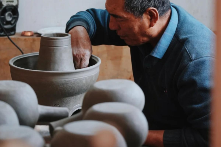 Artisan creating traditional black pottery in Garze, Sichuan