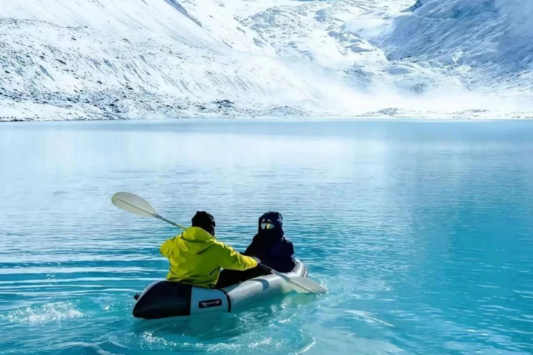 Leduomanin Ice Lake surrounded by snow mountains during a trekking journey in Western Sichuan China