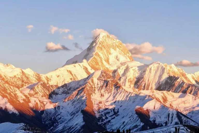 Golden sunlight illuminating snow mountains at Lenggacuo Lake in Sichuan