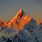 Golden sunlight shining on Meili Snow Mountain at sunrise