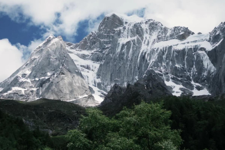 Summer scenery of Changpinggou Valley at Siguniang Mountain with snow-capped peaks