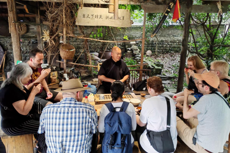 Emei Kung Fu inheritor Wang Hu explaining local martial arts traditions to travelers