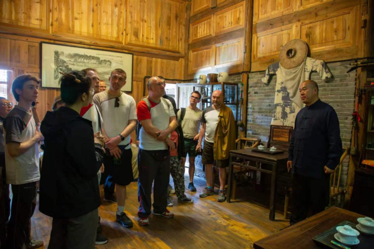 Emei Kung Fu inheritor Wang Hu guiding international visitors in Mt. Emei