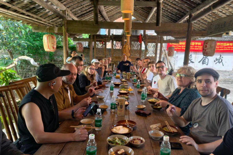 Emei Kung Fu inheritor Wang Hu sharing a local meal with travelers