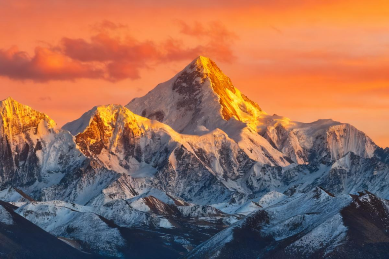 Golden alpenglow over Mt. Gongga seen from Beimeiduo in Western Sichuan